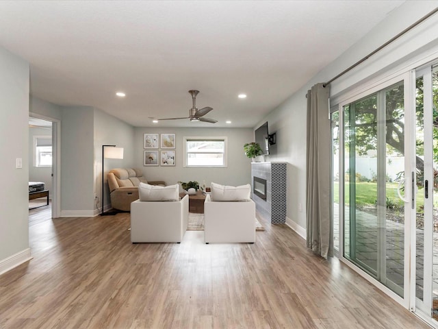 502 Duchess Dr, Lakeland, FL 33803 - living room with light wood-type flooring, baseboards, and a tiled fireplace