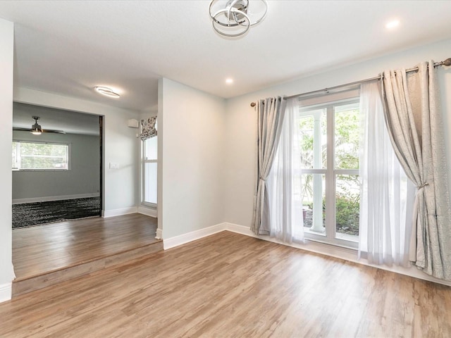 502 Duchess Dr, Lakeland, FL 33803 - unfurnished room with recessed lighting, baseboards, a notable chandelier, and wood finished floors