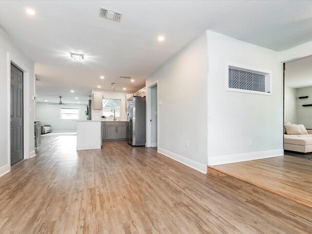 502 Duchess Dr, Lakeland, FL 33803 - unfurnished living room featuring a ceiling fan, visible vents, light wood-style flooring, and recessed lighting