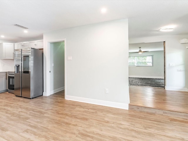 502 Duchess Dr, Lakeland, FL 33803 - unfurnished living room featuring a ceiling fan, baseboards, visible vents, and light wood-type flooring