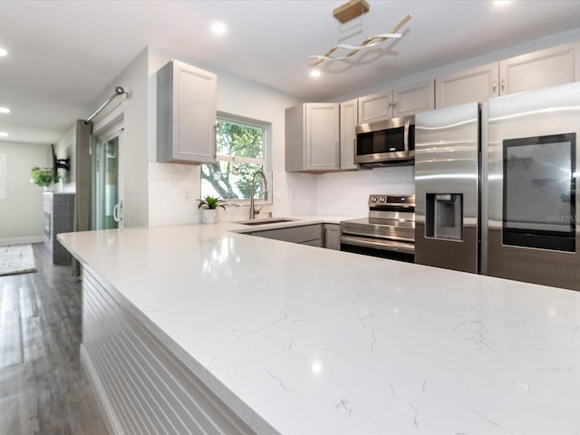 502 Duchess Dr, Lakeland, FL 33803 - kitchen with gray cabinets, wood finished floors, a sink, stainless steel appliances, and recessed lighting