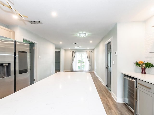 502 Duchess Dr, Lakeland, FL 33803 - kitchen with light wood-style floors, visible vents, stainless steel fridge with ice dispenser, wine cooler, and recessed lighting