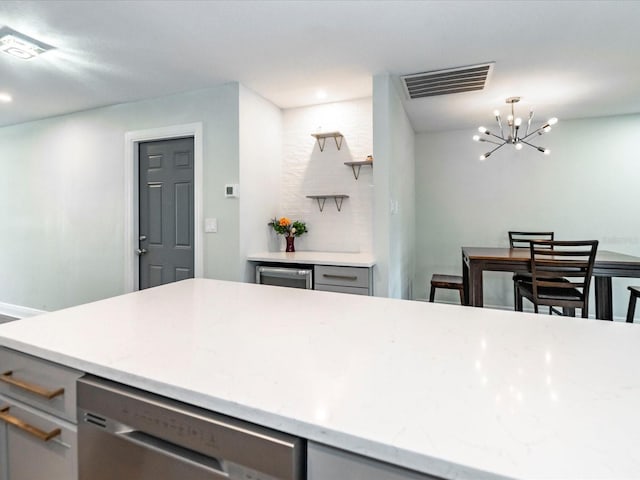 502 Duchess Dr, Lakeland, FL 33803 - kitchen featuring gray cabinetry, stainless steel dishwasher, a chandelier, and visible vents
