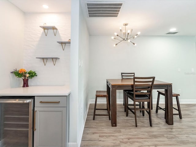 502 Duchess Dr, Lakeland, FL 33803 - dining space featuring visible vents, wine cooler, a chandelier, and light wood-type flooring
