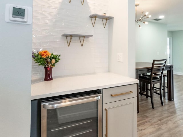502 Duchess Dr, Lakeland, FL 33803 - bar with an inviting chandelier, beverage cooler, light wood-style flooring, recessed lighting, and visible vents