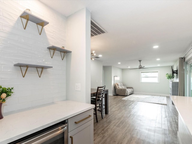 502 Duchess Dr, Lakeland, FL 33803 - bar with visible vents, wine cooler, wood finished floors, ceiling fan, and recessed lighting