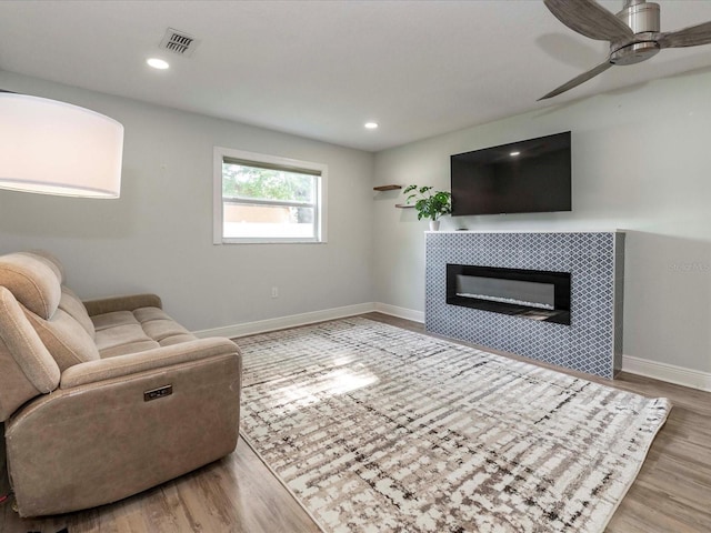 502 Duchess Dr, Lakeland, FL 33803 - living area with baseboards, visible vents, wood finished floors, and a tile fireplace