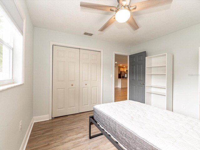 502 Duchess Dr, Lakeland, FL 33803 - bedroom with a ceiling fan, visible vents, baseboards, a closet, and light wood finished floors