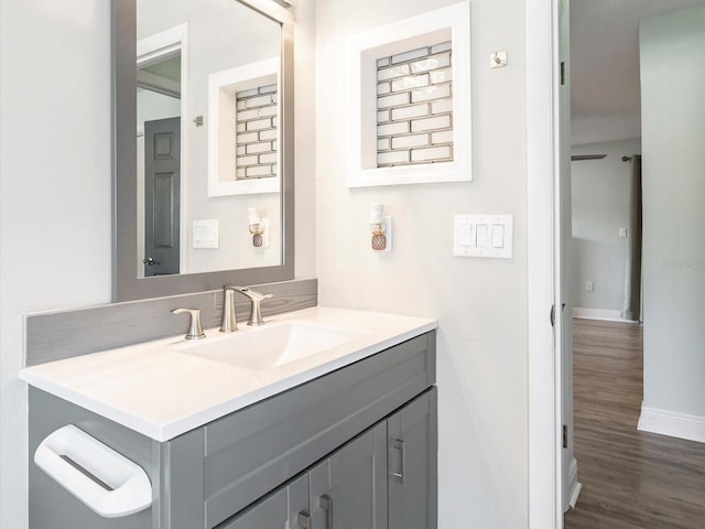 502 Duchess Dr, Lakeland, FL 33803 - bathroom featuring vanity, baseboards, and wood finished floors