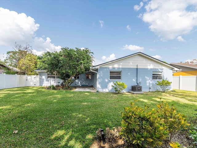 502 Duchess Dr, Lakeland, FL 33803 - rear view of property featuring a fenced backyard, central air condition unit, a yard, and a patio area