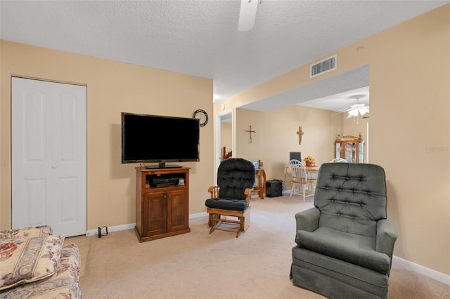 1130 N Lake Parker Ave Unit C321, Lakeland, FL 33805 - living area with a ceiling fan, a textured ceiling, visible vents, baseboards, and light carpet