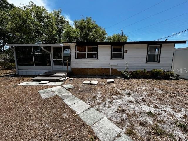 rear view of house with a sunroom