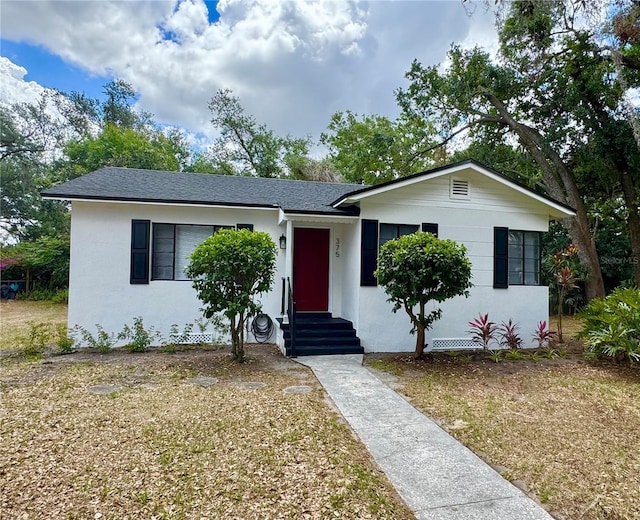 single story home with roof with shingles