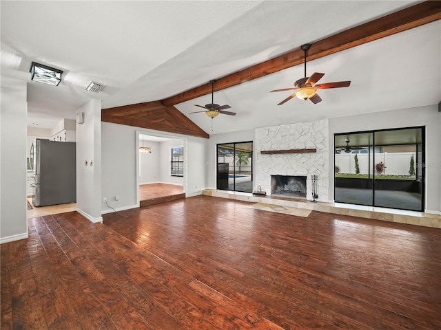 3002 Helms Dr, Auburndale, FL 33823 - unfurnished living room with a ceiling fan, a large fireplace, wood finished floors, baseboards, and lofted ceiling with beams