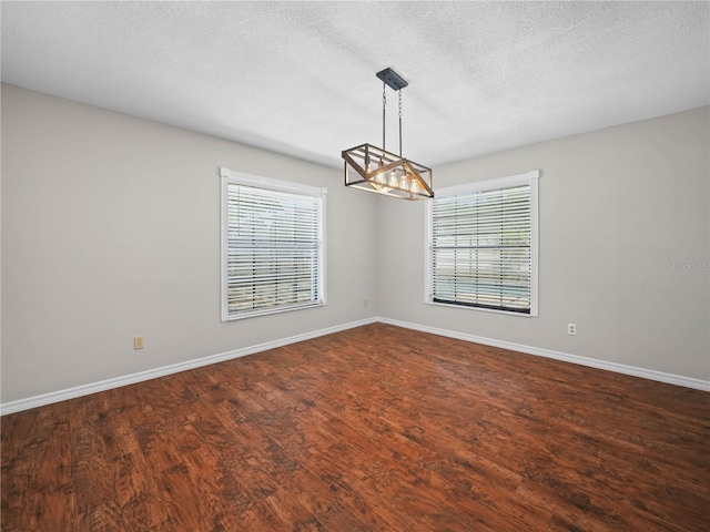 3002 Helms Dr, Auburndale, FL 33823 - empty room with an inviting chandelier, baseboards, and a healthy amount of sunlight
