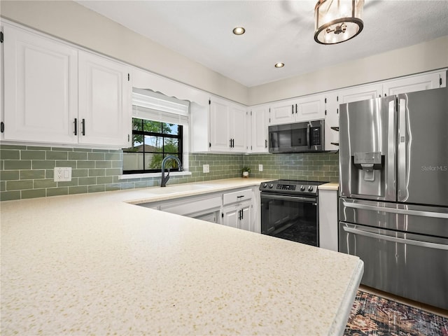 3002 Helms Dr, Auburndale, FL 33823 - kitchen with light countertops, a sink, white cabinetry, and stainless steel appliances