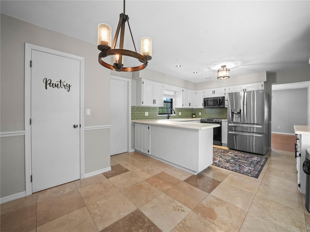 3002 Helms Dr, Auburndale, FL 33823 - kitchen featuring a peninsula, light countertops, tasteful backsplash, a notable chandelier, and stainless steel appliances