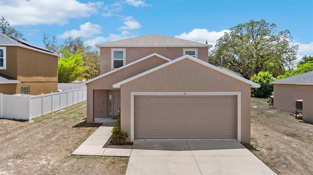 11 W Bay St, Davenport, FL 33837 - traditional home with driveway, an attached garage, and stucco siding