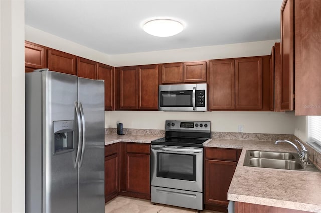 11 W Bay St, Davenport, FL 33837 - kitchen featuring stainless steel appliances, a sink, light countertops, and brown cabinetry