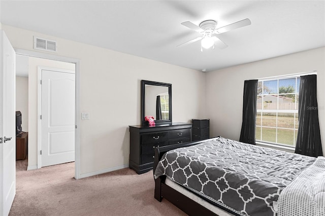 11 W Bay St, Davenport, FL 33837 - bedroom with light carpet, baseboards, and a ceiling fan