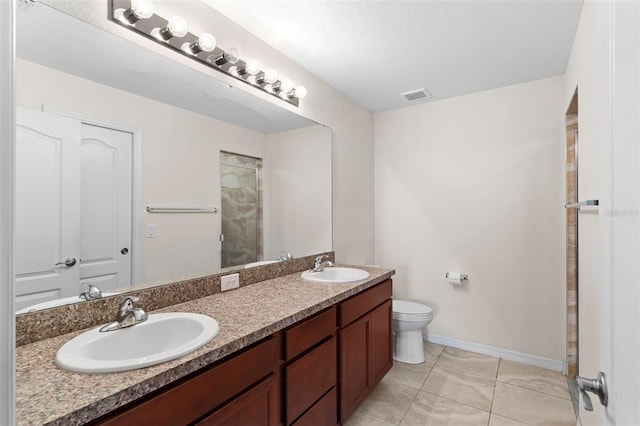 11 W Bay St, Davenport, FL 33837 - full bathroom featuring a shower stall, toilet, baseboards, and double vanity