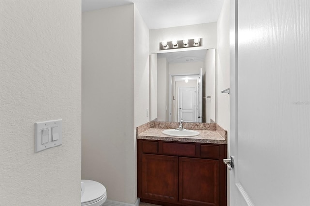 11 W Bay St, Davenport, FL 33837 - half bath featuring vanity, toilet, and a textured wall