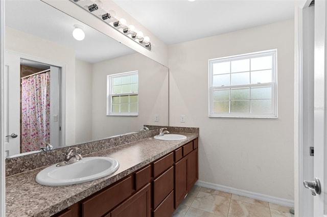 11 W Bay St, Davenport, FL 33837 - full bath featuring double vanity and baseboards