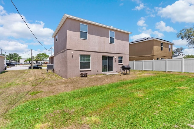 11 W Bay St, Davenport, FL 33837 - rear view of property with stucco siding and central AC