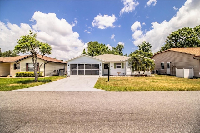 4976 Pleasant Hollow Trl, Lakeland, FL 33811 - single story home with a front lawn, a garage, a sunroom, central AC unit, and driveway