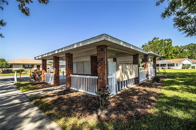 4976 Pleasant Hollow Trl, Lakeland, FL 33811 - view of home's exterior with brick siding, central AC unit, a yard, and mail area