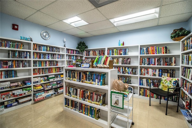 4976 Pleasant Hollow Trl, Lakeland, FL 33811 - sitting room with wall of books, a paneled ceiling, and tile patterned flooring