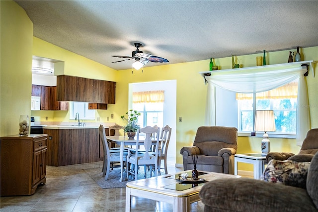4976 Pleasant Hollow Trl, Lakeland, FL 33811 - living area with light tile patterned floors, ceiling fan, vaulted ceiling, and a textured ceiling