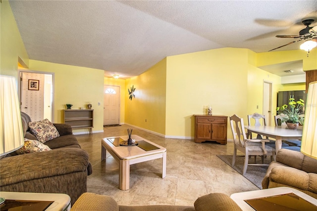 4976 Pleasant Hollow Trl, Lakeland, FL 33811 - living room featuring baseboards, ceiling fan, a textured ceiling, and lofted ceiling