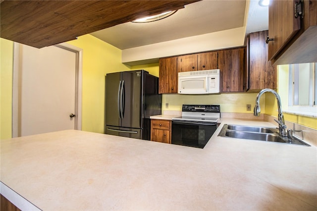 4976 Pleasant Hollow Trl, Lakeland, FL 33811 - kitchen with freestanding refrigerator, white microwave, light countertops, electric range oven, and a sink