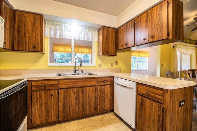4976 Pleasant Hollow Trl, Lakeland, FL 33811 - kitchen with light countertops, a peninsula, a sink, and dishwasher