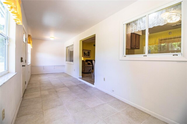 4976 Pleasant Hollow Trl, Lakeland, FL 33811 - spare room featuring light tile patterned floors, baseboards, and a wealth of natural light