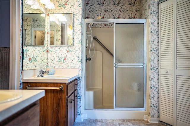 4976 Pleasant Hollow Trl, Lakeland, FL 33811 - bathroom featuring a closet, vanity, a shower stall, and wallpapered walls