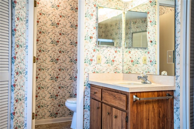 4976 Pleasant Hollow Trl, Lakeland, FL 33811 - bathroom with vanity, wallpapered walls, and toilet