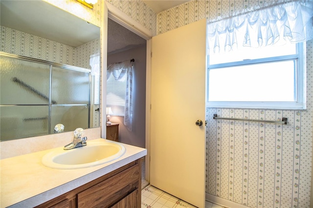 4976 Pleasant Hollow Trl, Lakeland, FL 33811 - bathroom featuring vanity, a shower with door, and wallpapered walls