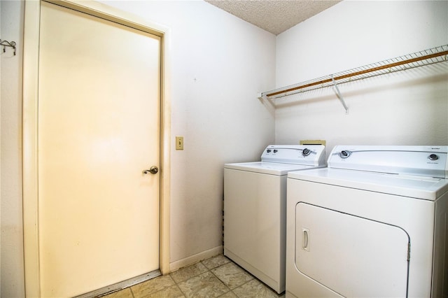 4976 Pleasant Hollow Trl, Lakeland, FL 33811 - clothes washing area featuring laundry area, a textured ceiling, baseboards, and washer and dryer
