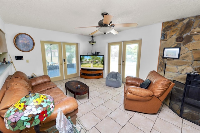 living room featuring french doors, a textured ceiling, ceiling fan, and light tile patterned floors