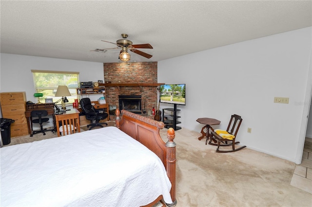 bedroom with light colored carpet, a brick fireplace, a textured ceiling, a ceiling fan, and baseboards