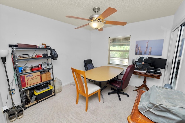 office space with carpet floors, a ceiling fan, and a textured ceiling