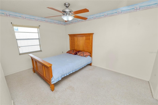 bedroom featuring a ceiling fan, baseboards, and light colored carpet