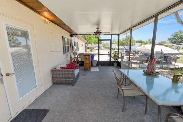 sunroom / solarium with outdoor dining area, a ceiling fan, and a wealth of natural light