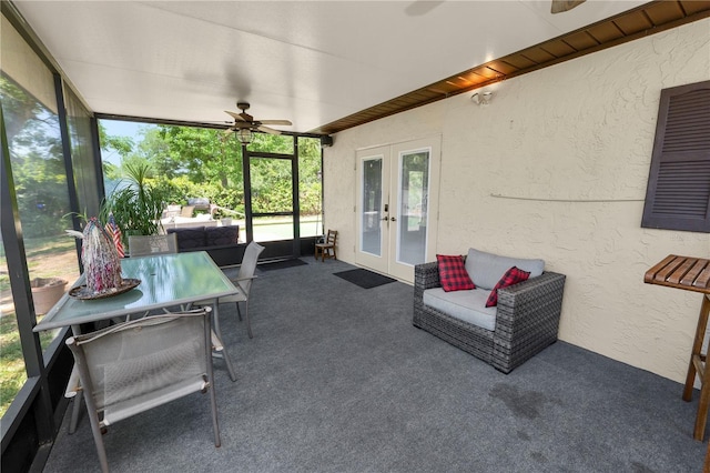 sunroom featuring a ceiling fan and french doors