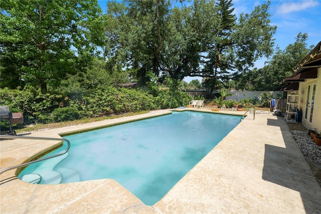 view of swimming pool featuring a fenced backyard, a fenced in pool, and a patio