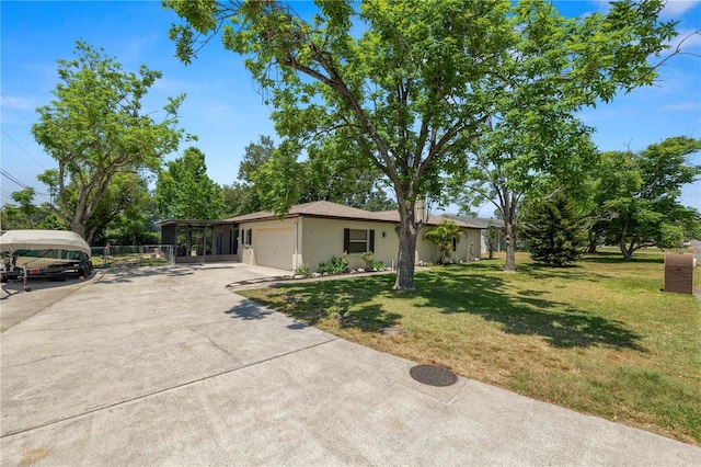 single story home featuring stucco siding, an attached garage, concrete driveway, and a front lawn