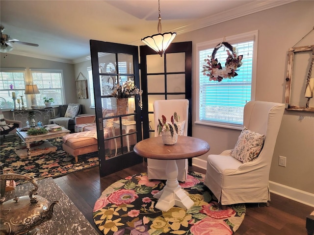 sitting room featuring a ceiling fan, baseboards, ornamental molding, and wood finished floors
