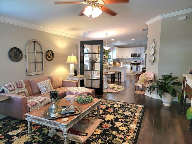 living room featuring wood-type flooring, a ceiling fan, recessed lighting, visible vents, and ornamental molding